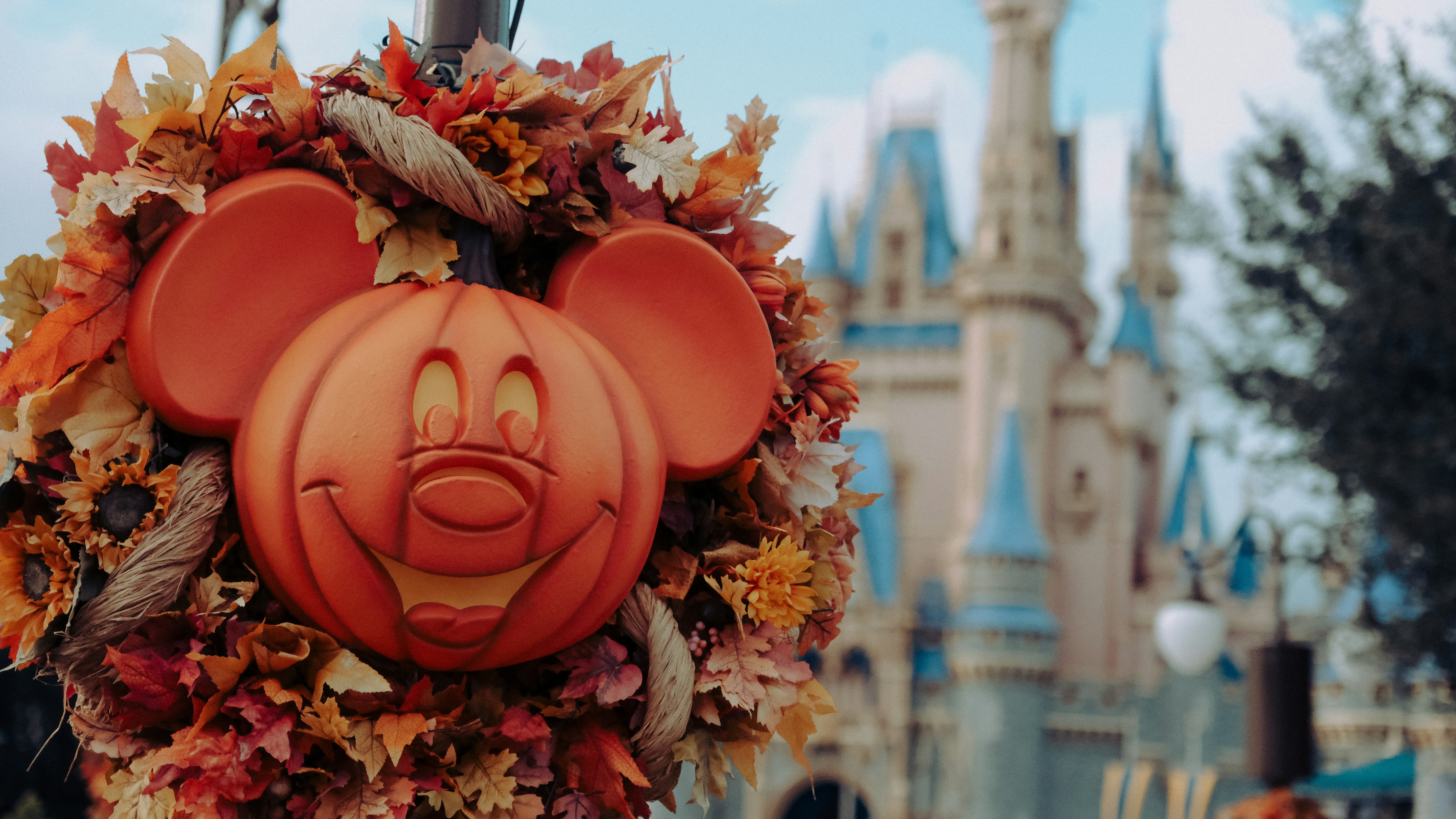 Mickey pumpkin decoration with Cinderella Castle in background fall at Disney World
